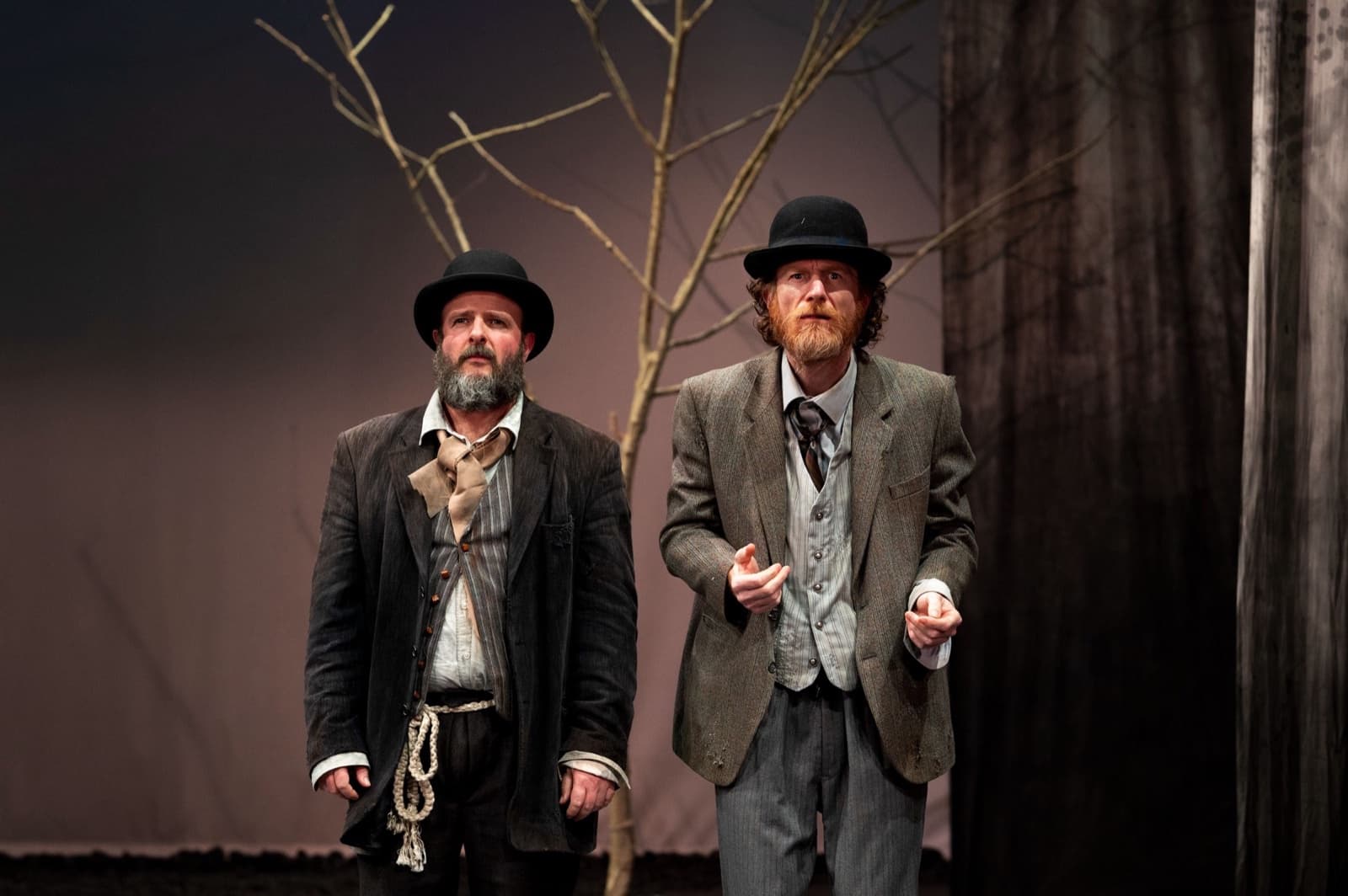 Estragon and Vladimir in bowler hats, standing side by side before the tree