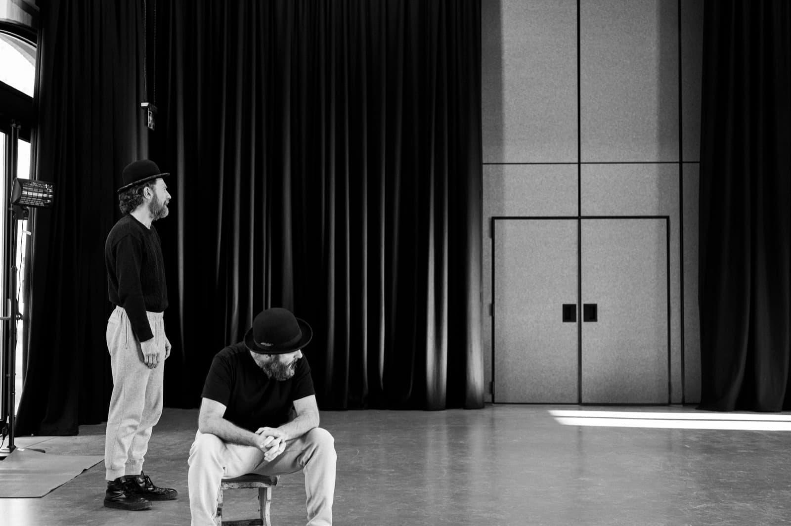 Vladimir standing beside a seated Estragon in the rehearsal room